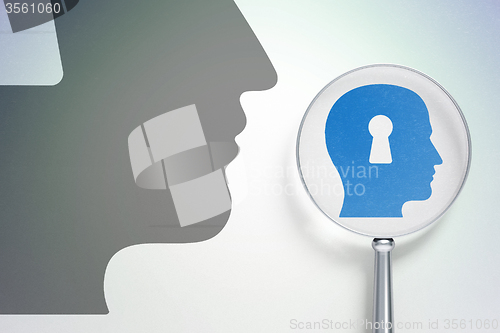Image of Marketing concept:  Head With Keyhole with optical glass on digital background