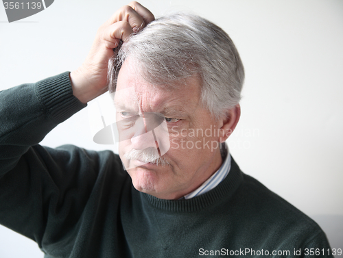 Image of Older man is frustrated.  