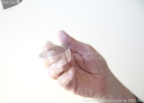 Image of Man gestures with hand.