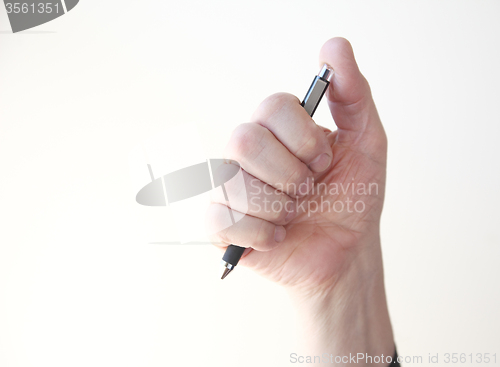 Image of man holding pen