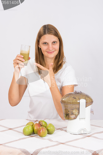 Image of She points to a glass of fresh juice