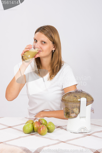 Image of Girl drinks freshly pear juice