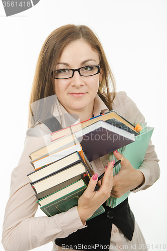 Image of Portrait of a teacher with books and notebooks