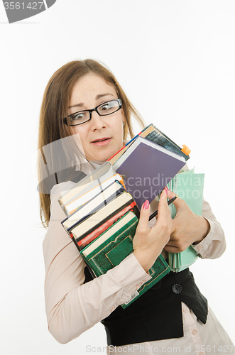 Image of Funny teacher with books and notebooks