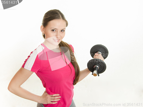 Image of Self-confident athlete with dumbbells in hand