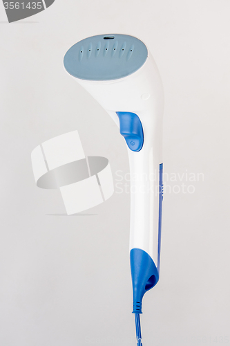 Image of Hand household steamer in three quarters on a light background