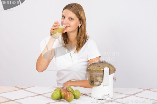Image of Girl freshly cooked pear juice and drink it