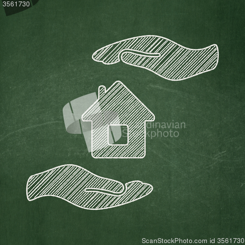 Image of Insurance concept: House And Palm on chalkboard background