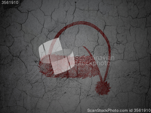 Image of Holiday concept: Christmas Hat on grunge wall background