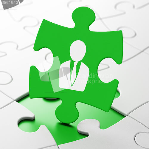 Image of Advertising concept: Business Man on puzzle background