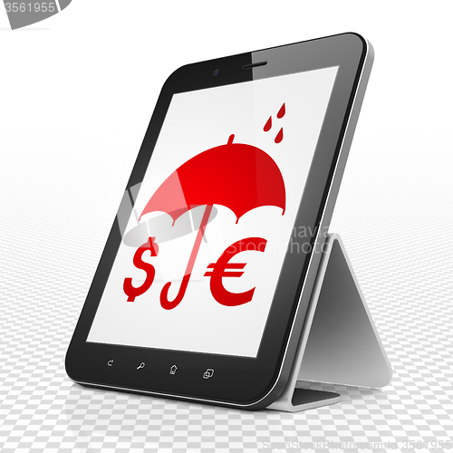 Image of Security concept: Tablet Computer with Money And Umbrella on display