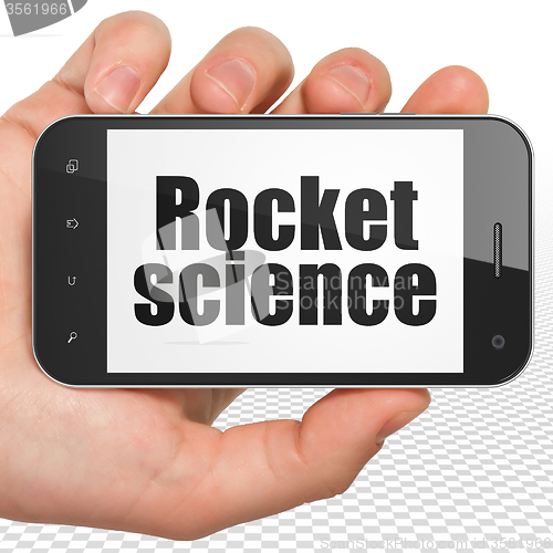 Image of Science concept: Hand Holding Smartphone with Rocket Science on display