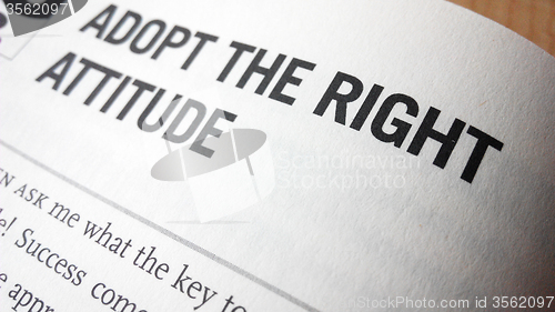 Image of Adopt the right attitude word on a book