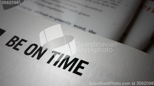 Image of Be on time word on a book