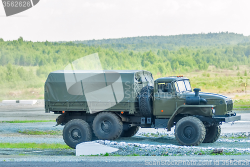 Image of URAL-4320 curtain sided truck comes around on high obstacle
