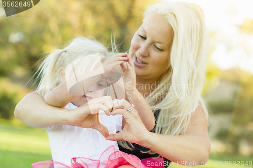 Image of Little Girl With Mother Making Heart Shape with Hands
