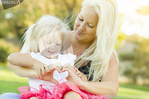 Image of Little Girl With Mother Making Heart Shape with Hands