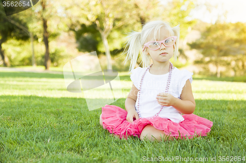 Image of Little Girl Playing Dress Up With Pink Glasses and Necklace