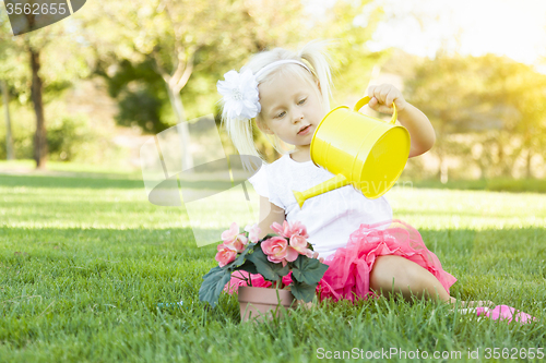 Image of Little Girl Playing Gardener with Her Tools and Flower Pot