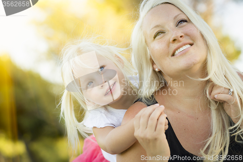 Image of Mother and Little Girl Having Fun Together in Grass