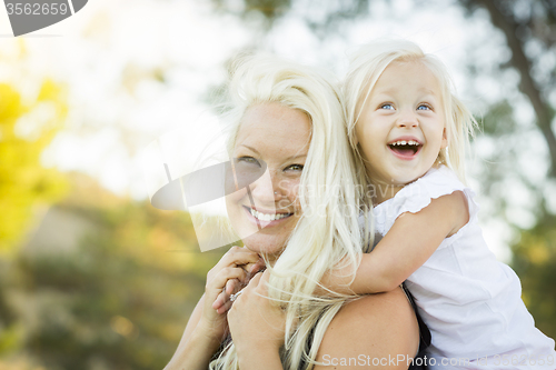 Image of Mother and Little Girl Having Fun Together in Grass