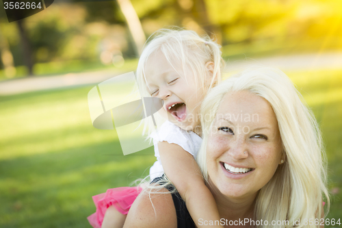 Image of Mother and Little Girl Having Fun Together in Grass