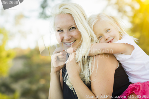Image of Mother and Little Girl Having Fun Together in Grass