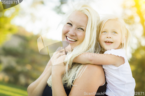 Image of Mother and Little Girl Having Fun Together in Grass