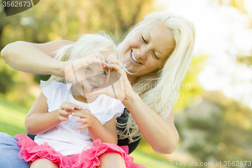 Image of Little Girl With Mother Making Heart Shape with Hands