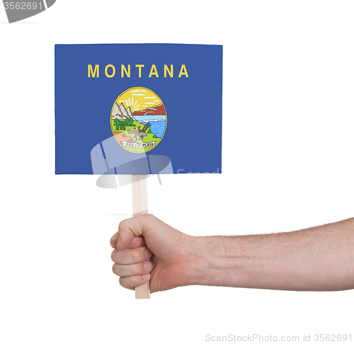 Image of Hand holding small card - Flag of Montana