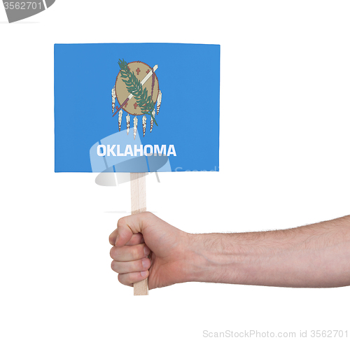 Image of Hand holding small card - Flag of Oklahoma