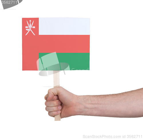 Image of Hand holding small card - Flag of Oman