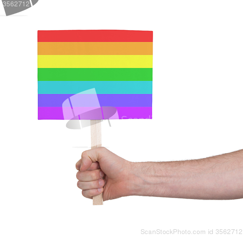 Image of Hand holding small card - Flag of Rainbow flag