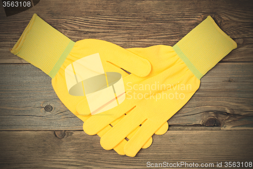 Image of handshake yellow construction gloves