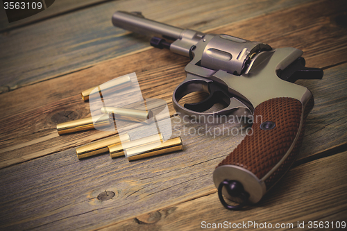 Image of Nagan revolver with cartridges