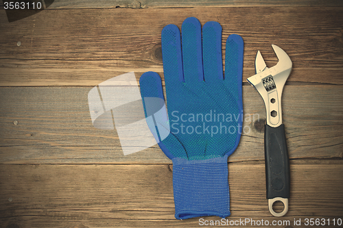 Image of Blue construction glove and wrench