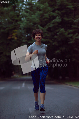 Image of woman  stretching before morning jogging