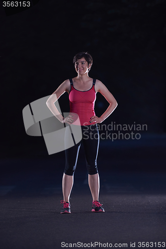 Image of woman  stretching before morning jogging