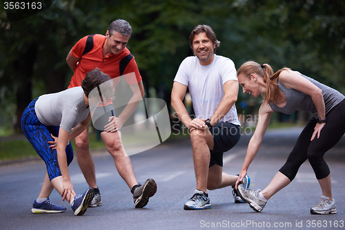 Image of jogging people group stretching