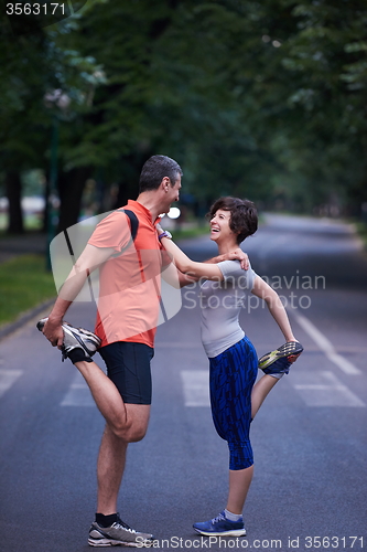 Image of jogging couple stretching