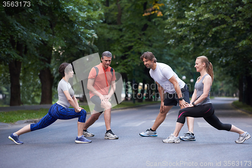 Image of jogging people group stretching