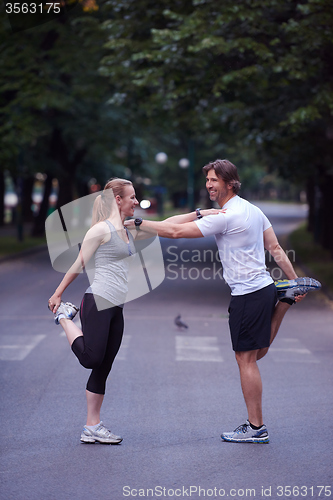 Image of jogging couple stretching