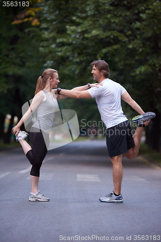 Image of jogging couple stretching
