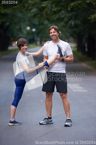 Image of jogging couple stretching