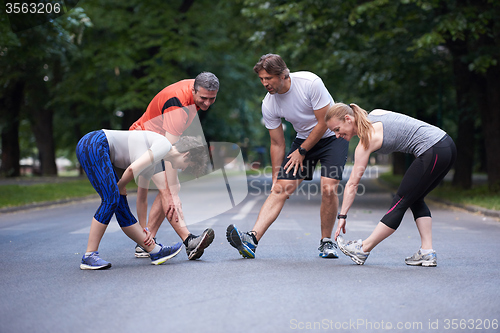 Image of jogging people group stretching