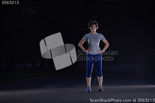 Image of woman  stretching before morning jogging
