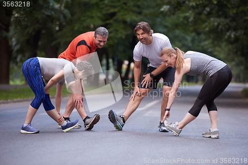 Image of jogging people group stretching