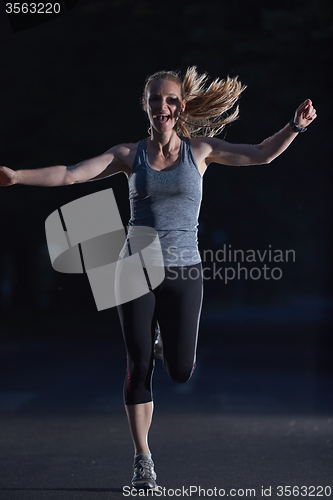 Image of woman  stretching before morning jogging