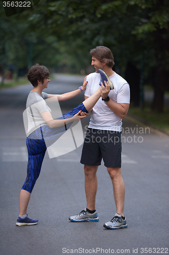 Image of jogging couple stretching