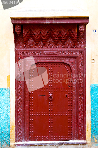 Image of old   in morocco  and wall ornate brown